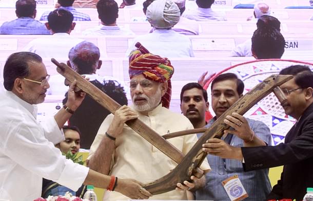 Prime Minister Narendra Modi being presented a model of plough by Agriculture Minister Radha Mohan Singh during the launch of DD Kisan Channel at a ceremony at Vigyan Bhawan on May 26, 2015 in New Delhi, India. Launching the channel for farmers on the first anniversary of his government, Modi said the agriculture sector had been neglected and there was need to make the sector vibrant. (Photo by Sanjeev Verma/Hindustan Times via Getty Images)